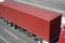 Red container and truck on road top view, cargo transportation and shipping concept