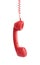 Red corded telephone handset hanging on white background. Hotline concept