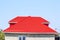 Red corrugated roof. House of cinder block. House with plastic windows and roof of corrugated sheet