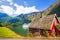 Red cottage against cruise ship in fjord, Flam, Norway