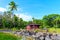 Red Cottage on a Serene Pond Amidst the Lush Greenery