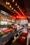 Red and cozy bar counter interior decorated with light bulbs, alcohol, liquors and spirits