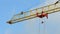 Red crane arm beam on the blue sky with white clouds transfer the heavy cargo