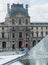 Red crane lifts window washers to second level of Louvre palace