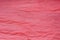 Red creased tissue papet background texture selective focus macro