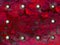 Red-crimson background imitating marble edged with rivets