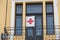 Red cross sign on residentual house balcony