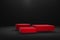 Red cube and cylinder on black color background stage for product promotion. Minimalist design, modern platform