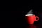 Red cup coffee on black background for love concept, relax concept, drinking concept for advertisement, selective focus on cup