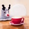 Red cup of coffee cappuccino and cute decorative knitted basket