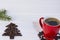 Red cup of coffee with christmas tree made of coffee beans on wooden table, copy space image, christmas coffee card