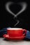 Red cup of hot coffee with smoke forms a heart symbol on black background. valentine`s day concept