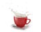 Red cup with milk splash, on white saucer with spoon. On white background