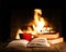 Red cup and old books on wooden table near fireplace.