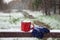 Red cup on a snow bridge in a winter park