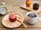 Red cupcakes put on a spherical wooden plate Beside of cupcake have Vintage alarm clock