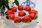 Red cupcakes in a shape of heart on banquet table.