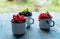 Red currant and black currants, raspberries fruit on old blue wooden table.