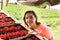 Red currant growers engineer working in garden with harvest, woman with box of berries