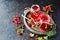 Red currant jam in curly glass jars on a black concrete background. Jam recipes. Harvest berries