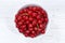 Red currants berries from above bowl wooden board