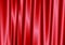 Red curtain reflect with light spot on background.