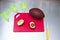 Red cutting board, american football ball, avocado cut in the middle, knife and banner on metal table