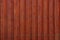 Red dark background of wooden fence boards