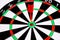 Red dart arrow hitting in the target center of dartboard