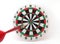 red dart arrow moving straight to goal in bullseye of colorful dartboard isolated on white background