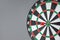 Red dart hitting a target on center of Bullseye or Dartboard. Business, competition, goal, success and marketing concept