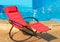 Red deck-chair on the wooden floor