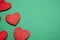Red decorative hearts over green background. Valentine`s Day, love celebration.
