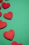 Red decorative hearts over green background. Valentine`s Day, love celebration.