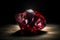 Red diamond is a rare precious natural geological stone on a black background in low key. AI generated.