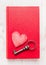 Red diary book with heart and vintage key on white wooden background, top view. Valentines day card.