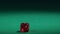 Red dice falling on green table in slow motion. Casino gambling, hobby for rich
