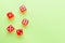 Red dice lying on a green background. Place for text