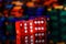 Red dices with reflection and casino chips on a black blurred background