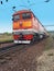 Red diesel locomotive on the tracks in motion