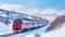 Red Diesel Train Glides through a Snowy Railway Platform in Exhilarating Motion. Generative AI