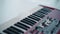 Red digital piano keyboard with buttons and keys. Musical synthesizer closeup. Concept nobody