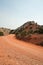 Red dirt and gravel Crooked Creek Road through the Pryor Mountains in Wyoming