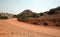 Red dirt and gravel Crooked Creek Road through the Pryor Mountains in Wyoming