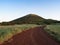 A Red Dirt Road Leading to Capulin Volcano in New Mexico