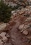 Red Dirt Trail Cuts Around Rocky Cliffside