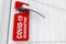 Red Do Not Disturb Door Label with COVID-19 Quarantine Sign on a Hotel, Home or Room Door Handle. 3d Rendering