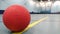 Red dodge ball on the line in sportshall