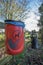 Red dog waste bin. Responsible pet ownership.