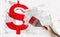 Red dollar sign and brush in hand on grundge white grey background. Currency money financial concept